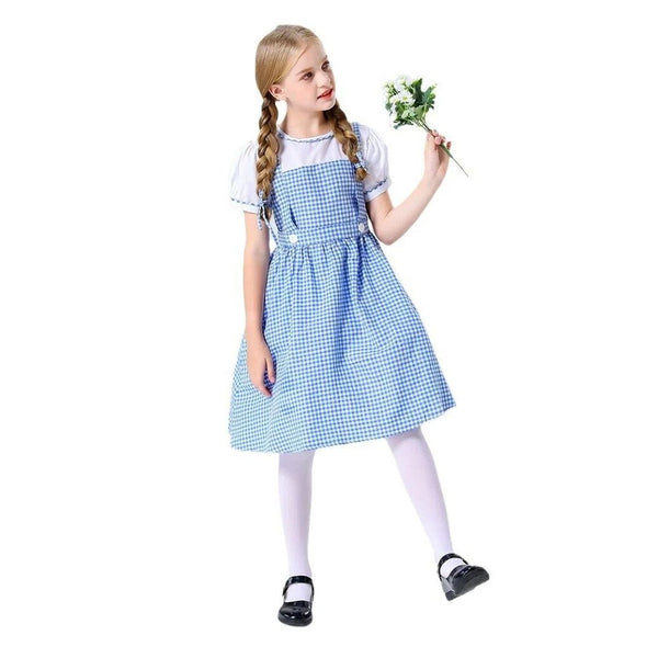 Girl wearing Dorothy gingham costume holding flowers, playful pose
