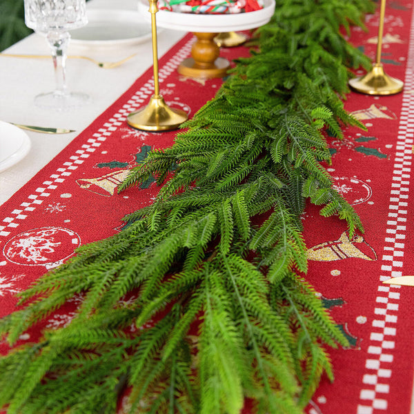 Christmas garland laid along a dining table as a greenery runner