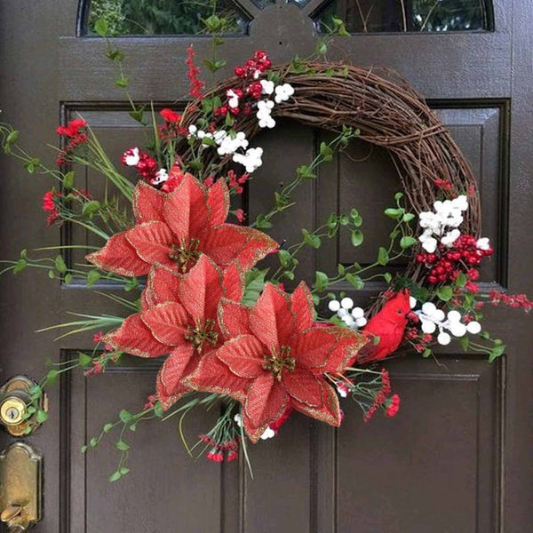 Red poinsettia flowers on a grapevine door wreath