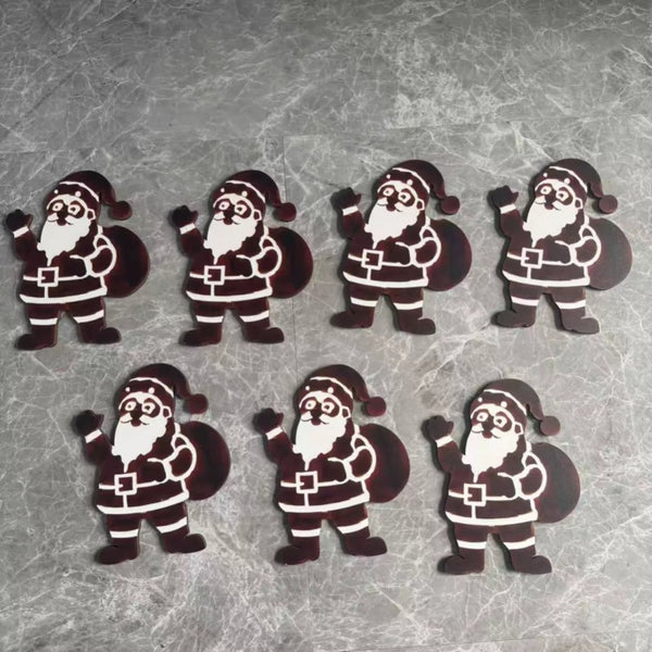 Seven wooden Santa wall decoration cut-outs laid flat