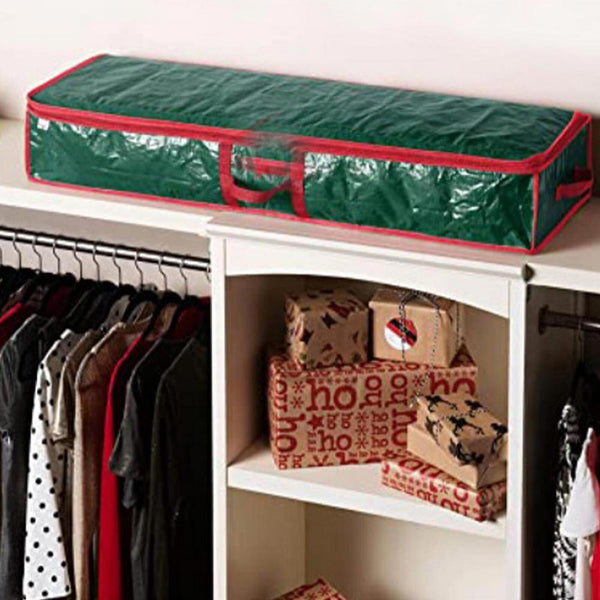 Green storage bag on a wardrobe shelf above hanging clothes