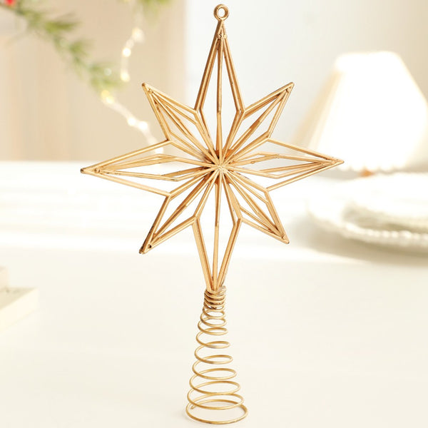 Gold 8-point star tree topper standing on a table