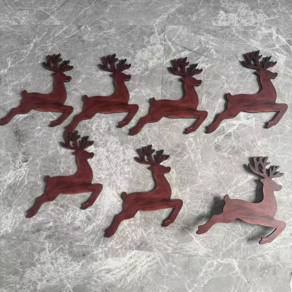 Seven wooden reindeer wall decoration cut-outs laid flat