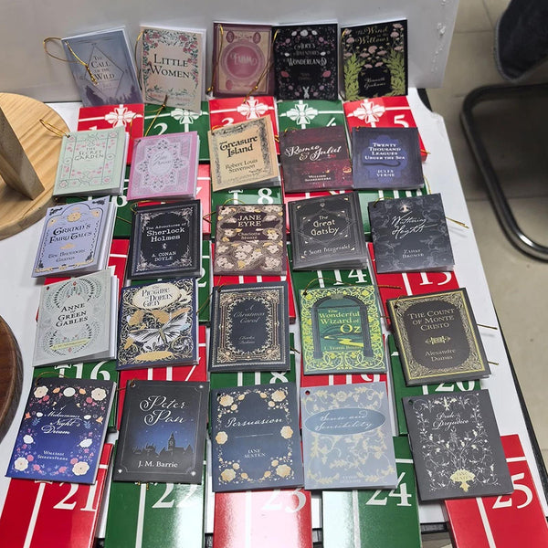 24 mini book covers laid out on their numbered boxes