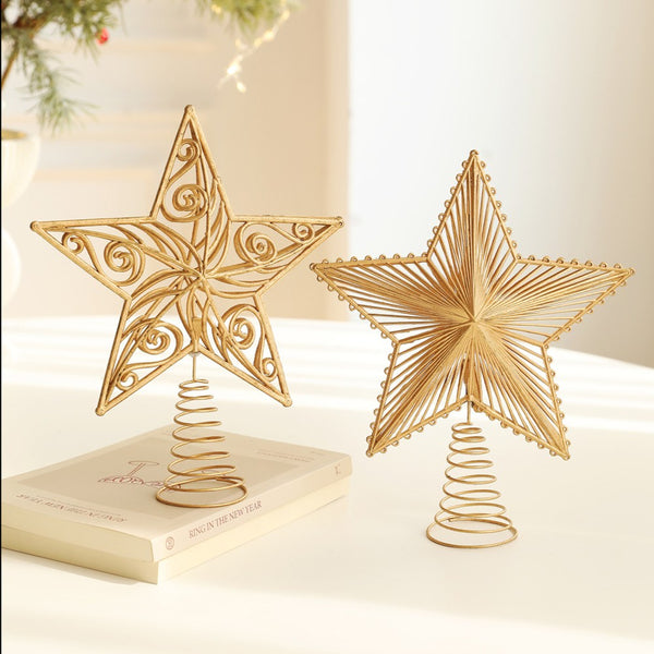 Filigree and layered gold star toppers standing on a table