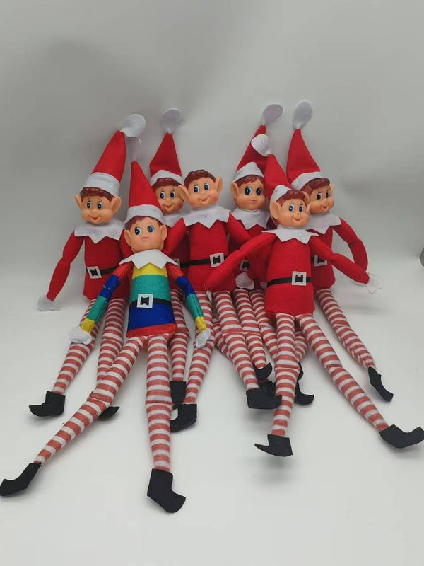 Group of red and rainbow Christmas elf dolls sitting together
