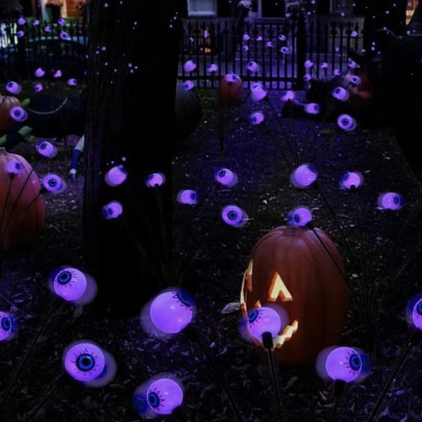 Six pack of solar eyeball Halloween lights in a garden pot