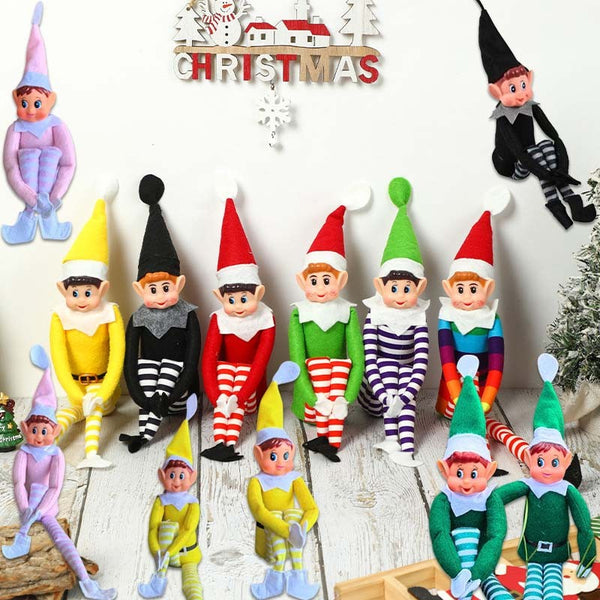 Nine Christmas elf dolls in different colours on a shelf under a Christmas sign
