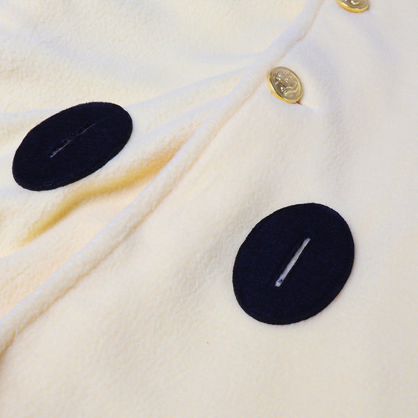 Close-up of the soft brushed cape fabric, gold buttons and black toggle