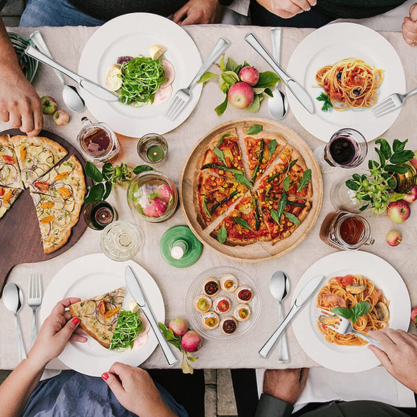 Party guests eating from gold rimmed plastic plates