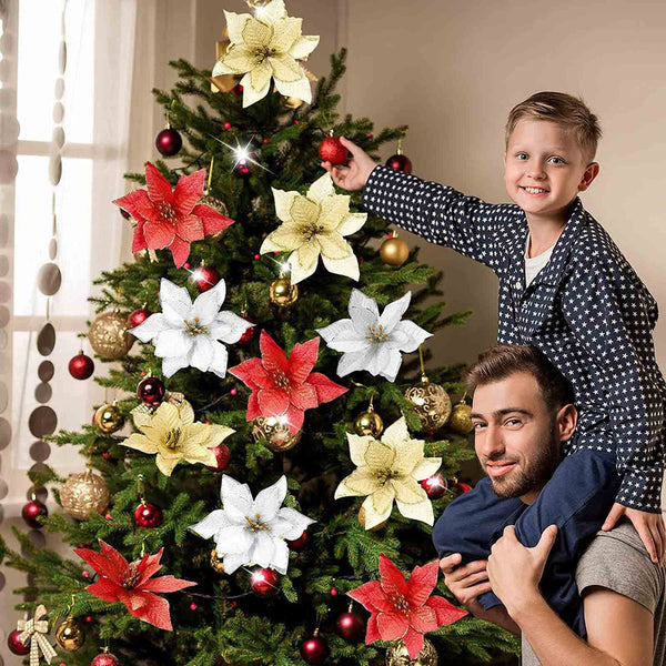 Father and son decorating a Christmas tree with poinsettia flowers