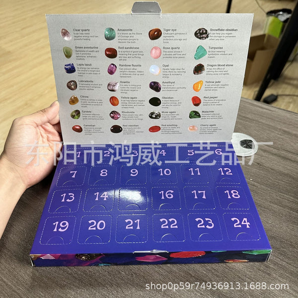 Hand holding an open mineral advent calendar with gem list card and numbered doors