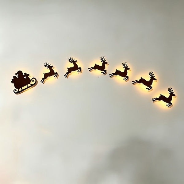 Light up Santa sleigh and reindeer Christmas wall decoration set on a wall