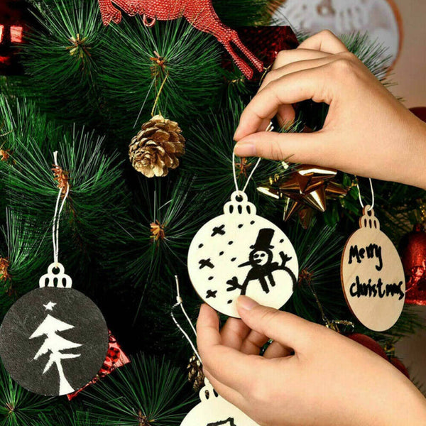 Hand-painted round wooden ornaments being hung on a tree