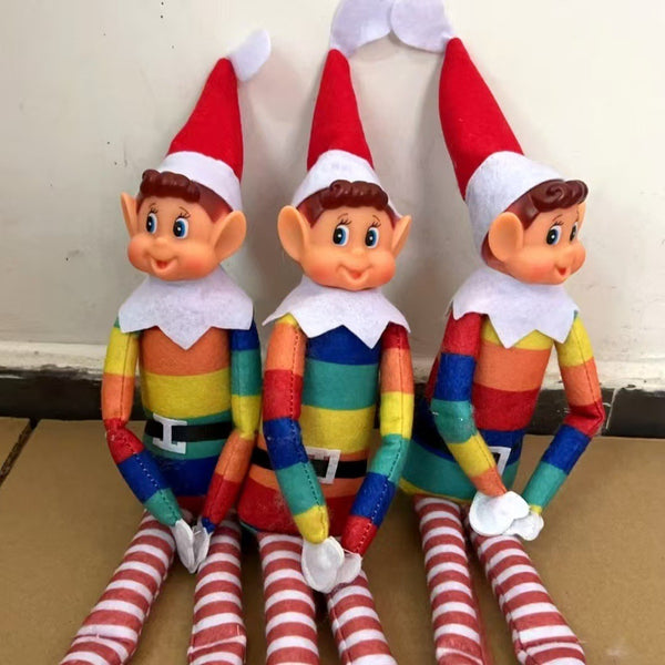 Three rainbow Christmas elf dolls sitting in a row