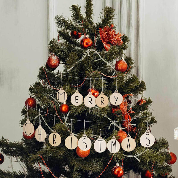 Round wooden ornaments painted with letters spelling Merry Christmas