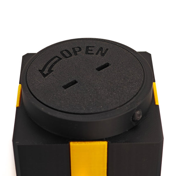Screw-top lid of the prank gift box marked OPEN with an arrow