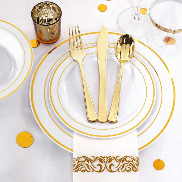Gold party plate setting on a table with confetti