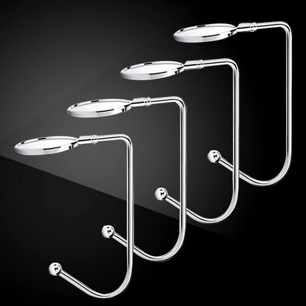 Four silver stocking holders on a black background
