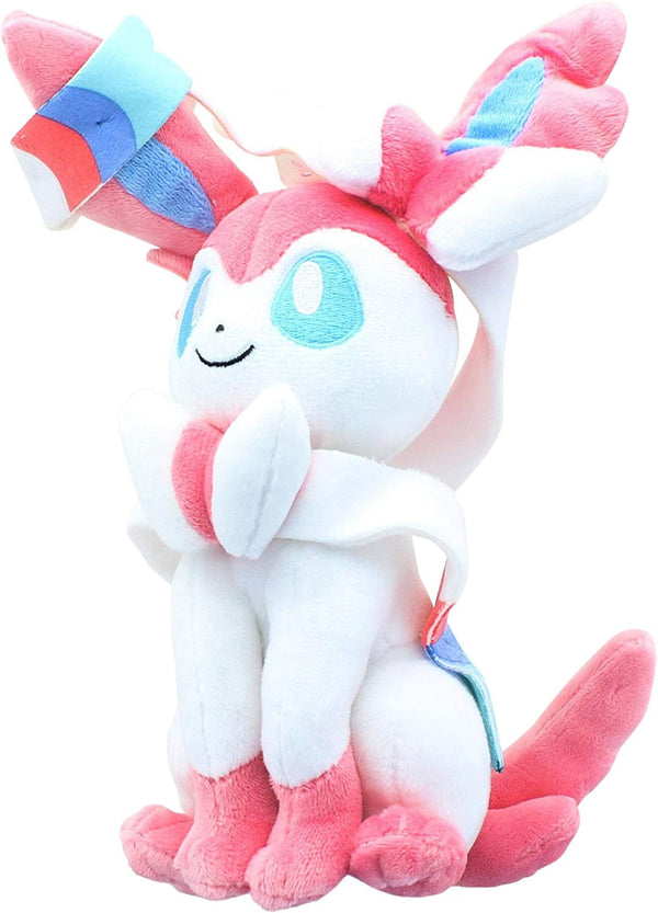 Close-up of the pink plush toy with blue eyes and neck bow