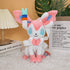 Pink fox plush toy sitting on a bed