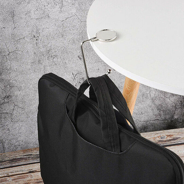 Table bag hook holding a laptop bag on a round table