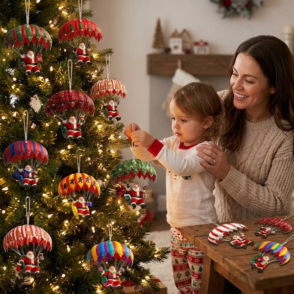 Mother and toddler hanging Santa parachute ornaments on the Christmas tree