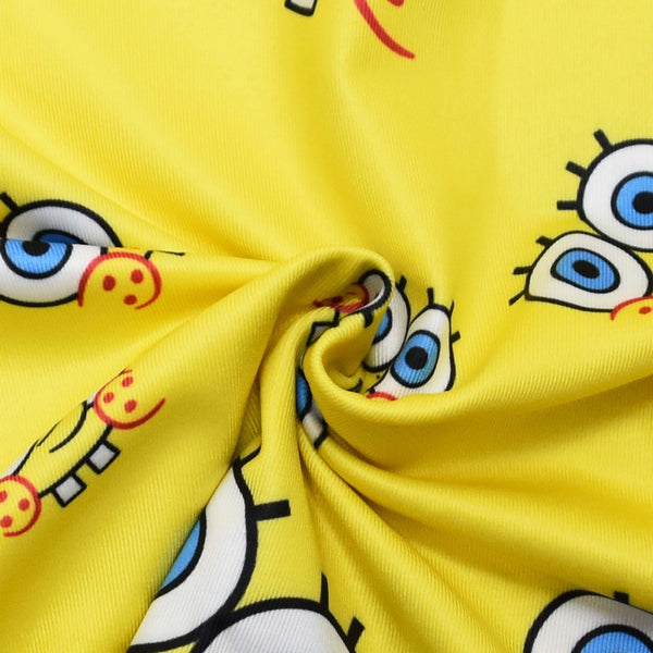 Close-up of the SpongeBob character print fabric on the yellow dress