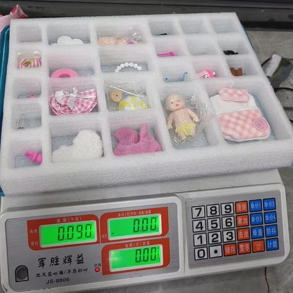 Inside tray with a mini baby doll and accessories in compartments