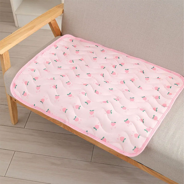 Pink pet cooling mat on a sofa
