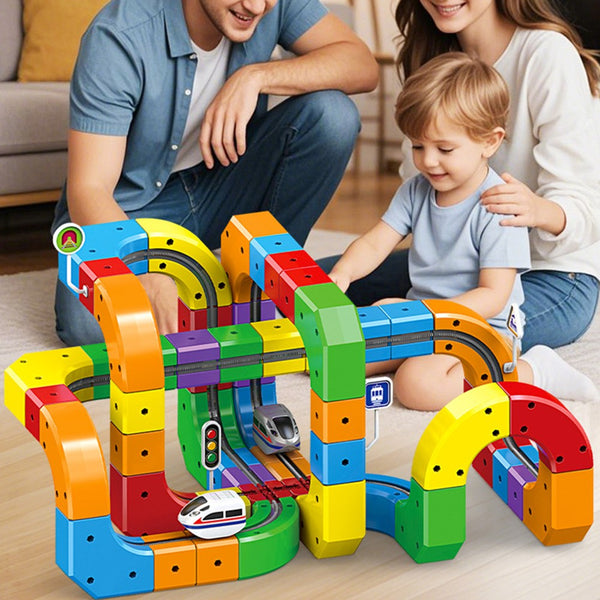 Parents and child building a rainbow cube train track on the floor