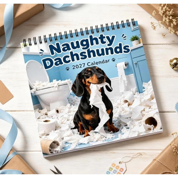 Funny dog calendar 2027 lying on a white table with ribbon