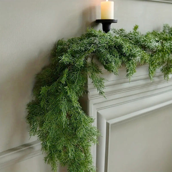 Artificial pine garland draped across a fireplace mantel