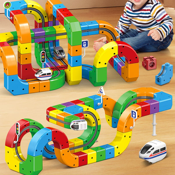 Child playing with a large rainbow cube train track layout