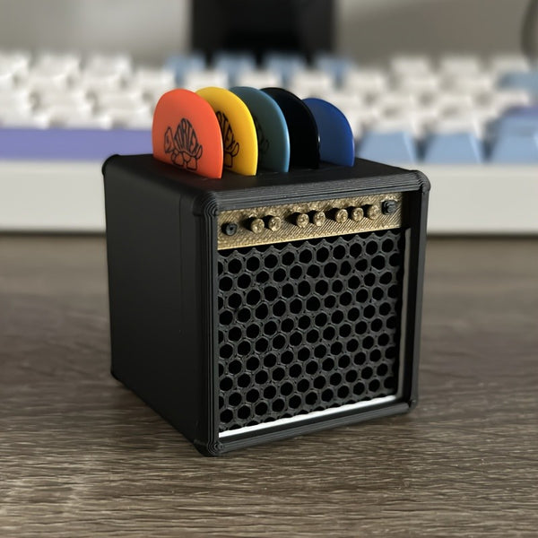 Guitar pick holder held in the hand for scale