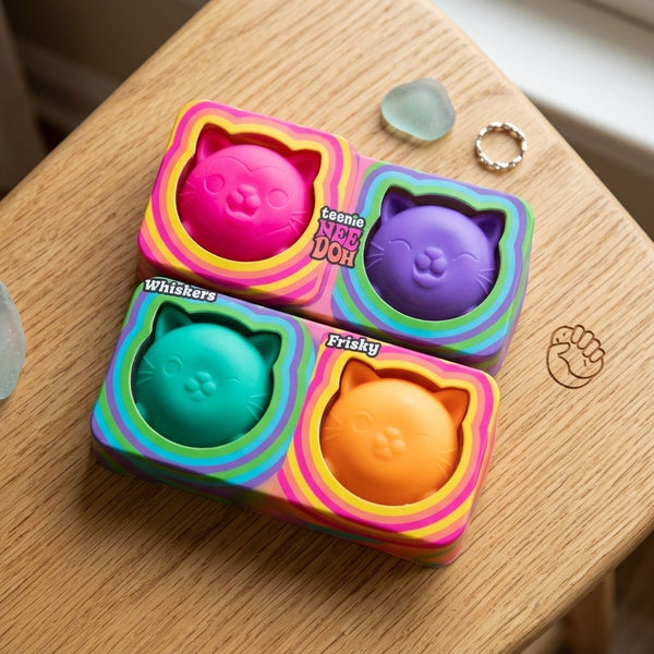 Pink, purple, green and orange squishy cats in their tray