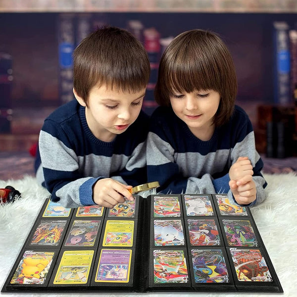 Two boys looking at cards in a trading card binder