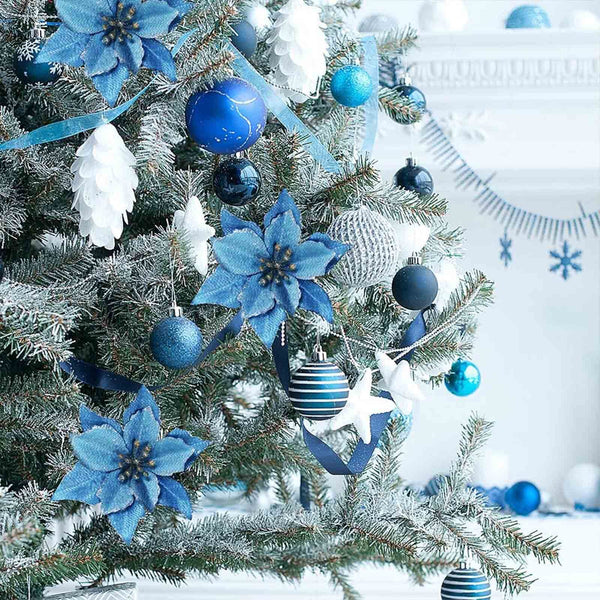 Blue glitter poinsettias on a frosted Christmas tree
