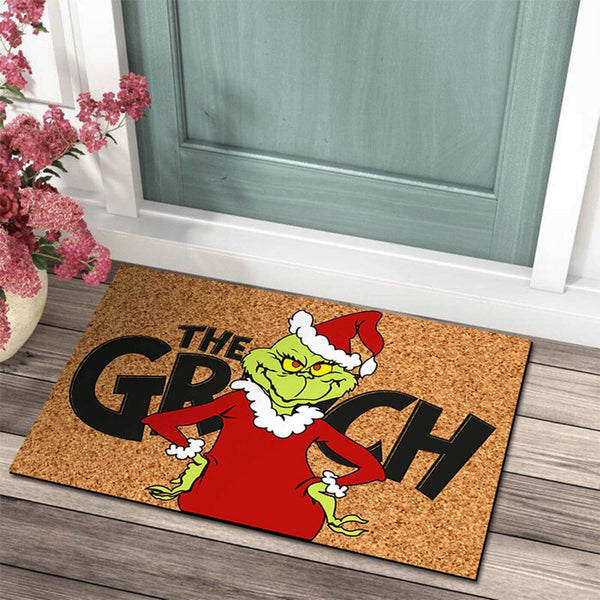 Green grump doormat outside a front door